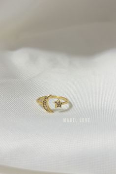 Moon & Star Gold Ring This stunning Moon & Star Gold Ring is an eye-catching accessory crafted from solid gold. It features an intricate design with a crescent moon paired with a star, creating a unique piece sure to be treasured. Enjoy classic elegance with a modern twist. Gold Moon Charm Promise Ring, Celestial Style Open Ring With Moon Charm, Gold Moon-shaped Midi Rings As Gift, Gold Moon Shaped Midi Rings As Gift, Gold Moon Midi Rings As A Gift, Celestial Gold Crescent Rings, Gold Promise Ring With Moon Charm, Celestial Crescent Gold Rings, Gold Celestial Moon Ring