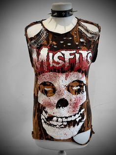 THE STITCHES Distressed Rock collection - This Misfits t-shirt is a handmade bleached crop top/t-shirt made with a brand new officially licensed band shirt. - Distressed Misfits  crop top/shirt - Safety pin unisex hand-made crop/tee - Material: Bleached cotton Measurements - Fit UK 8-12, US4-8 - Width (armpit to armpit) : 18 Inches  - Length (top of collar to bottom): 25 inches Care instructions: - This is a distressed item and will require proper care, it should be washed inside out gently and Distressed Rock T-shirt For Streetwear, Distressed Skull T-shirt In Edgy Style, Distressed Crew Neck Top For Festival, Edgy Acid Wash Distressed T-shirt, Edgy Distressed Tops For Festival, Distressed Punk T-shirt For Summer, Distressed Punk T-shirt, Distressed Skull Top In Punk Style, Alternative Distressed Halloween T-shirt