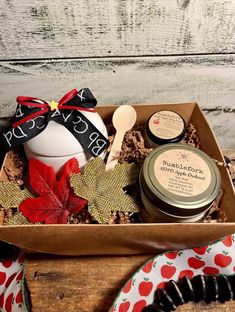 a wooden box filled with cookies, cream and other items on top of a table