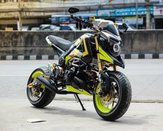 a yellow and black motorcycle parked on the street