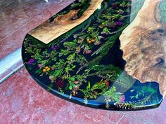 the table is made out of wood and has plants growing on it's surface