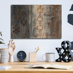 a wooden table topped with lots of different types of art and decor on top of it