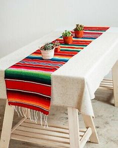 a long table with two potted plants on it