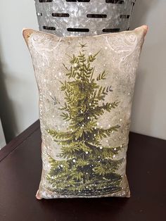 two decorative pillows sitting on top of a table