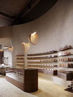 the interior of a store with shelves and lamps