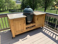 an outdoor grill on the back deck of a house