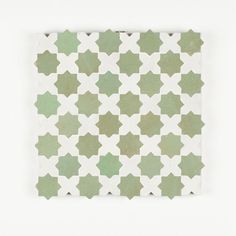 a green and white tile pattern on the wall