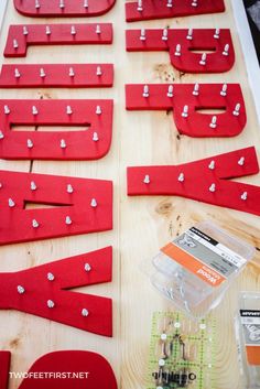 some red pieces of wood with white pins on them