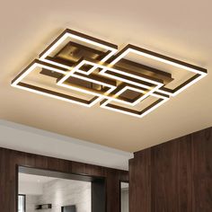 a modern ceiling light with square and rectangle shapes on the ceiling in a living room