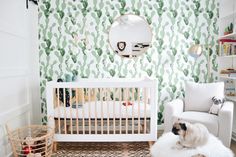 a baby's room with cactus wallpaper and a white crib