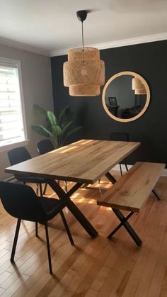 a dining room table and chairs with a bench in front of the mirror on the wall