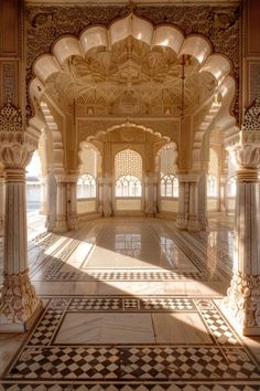 the inside of an ornate building with marble floors and arches on either side of it