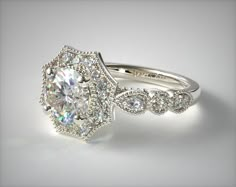 a diamond ring with an oval center surrounded by smaller round diamonds