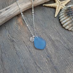 WEAR THE ENERGY OF THE SEA The jewelry that carries the energy of the sea!  Beautiful and shinning sterling silver oval link chain necklace with the genuine ice blue color sea glass pendant that you make personal with an initial/design stamped on the round 6mm sterling silver plate.  Simple and minimalist look for any occasion and perfect for everyday wear, as a meaningful gift or for beach lovers who can connect and carry the energy of the sea. GENUINE SEA GLASS: weathered and smoothed pieces o Personalized Blue Minimalist Jewelry, Blue Minimalist Personalized Jewelry, Personalized Blue Sterling Silver Necklace, Blue Ocean-inspired Jewelry For Anniversary, Ocean-inspired Blue Jewelry For Anniversary, Ocean-inspired Sterling Silver Jewelry For Anniversary, Round Sea Glass Jewelry Gift, Seaglass Necklaces, Round Sea Glass Necklace As A Gift