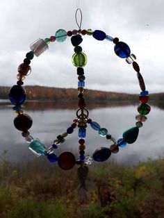 a wind chime hanging in front of a body of water