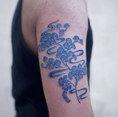 a man with a blue tattoo on his arm