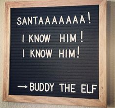 a sign that says buddy the elf in white writing on a black board with wood frame