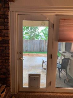 an open door leading to a patio with a dog bowl on the ground in front of it