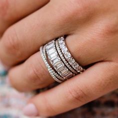 a woman's hand with three rings on it