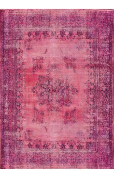 an antique rug with pink and purple colors