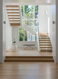 an empty room with stairs leading up to the second floor