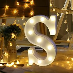 the letters s and s are lit up with fairy lights