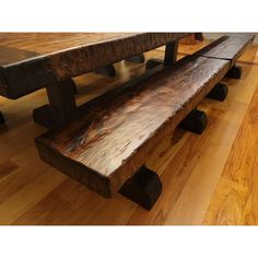 a wooden bench sitting on top of a hard wood floor