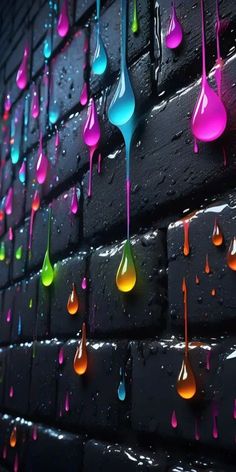 colorful drops of water hanging from the side of a brick wall