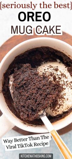 a cup filled with cake and cream on top of a table