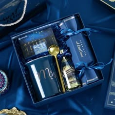 a blue box with gold spoons and other items