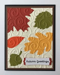 an autumn greeting card with leaves and acorns on the front, which reads autumn greeting