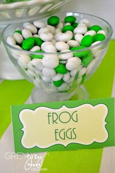 green and white candies in a glass bowl on a table with a name tag