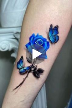 a blue rose and two butterflies on the arm