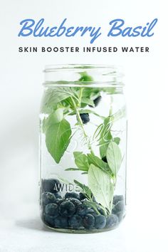 a jar filled with blueberries and basil