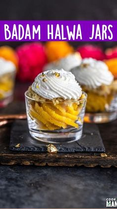 three small desserts with whipped cream and fruit on the side, sitting on a slate board