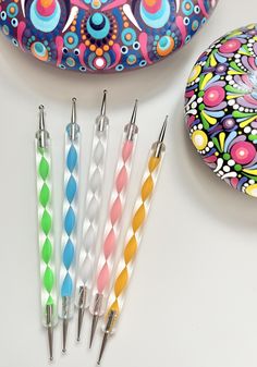 four different colored toothbrushes sitting next to each other