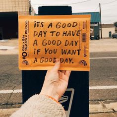 someone holding up a sign that says it's a good day to have a good day if you want a good day