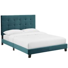 a bed with a blue headboard and white sheets on top of it, against a white background