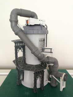 a white and gray machine sitting on top of a green mat