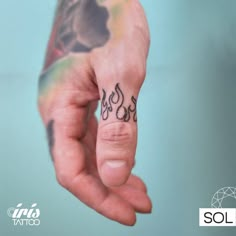 a hand with a small tattoo on it