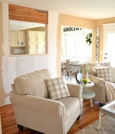 a living room filled with furniture and a mirror