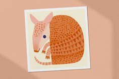 an orange and white armadile with blue eyes on a pink background is featured in this postcard