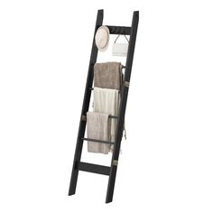 a ladder shelf with towels and other items on top of it in front of a white background