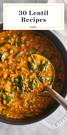 a spoon full of lentil soup with spinach and cheese in it, on top of