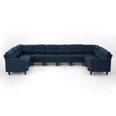 a large blue sectional couch sitting on top of a white floor