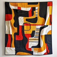 an abstract quilt hanging on the wall