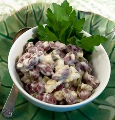 a white bowl filled with food on top of a green plate