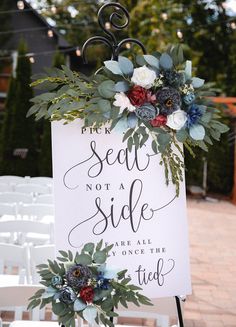 a sign with flowers and greenery on it that says the seat not a side