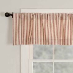 a window with a striped valance hanging from it's side