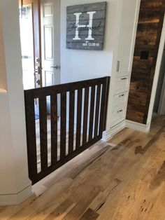 an empty room with wood floors and white walls is seen in this image from the hallway